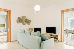 a living room with a couch and a tv at Villa Luce Luxury Accomodation in Polignano a Mare