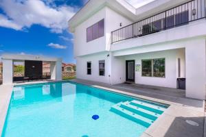 a swimming pool in front of a house at Mountain View Pool House Villa in El Paso