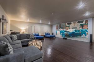 a living room with a couch and a painting of a car at Mountain View Pool House Villa in El Paso