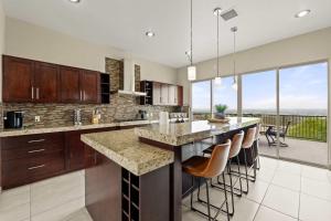 a kitchen with a large island with bar stools at Mountain View Pool House Villa in El Paso