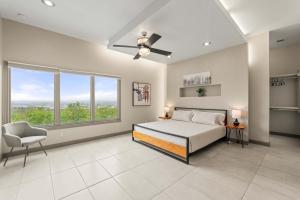a bedroom with a bed and a ceiling fan at Mountain View Pool House Villa in El Paso