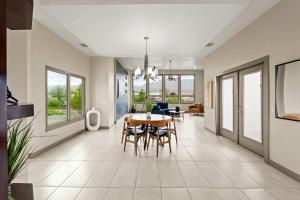 a dining room and living room with a table and chairs at Mountain View Pool House Villa in El Paso +53 photos