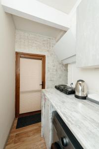 a kitchen with a counter top and a door at Studio Room Central in Chişinău