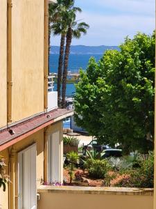 a view of the ocean from a building at Hôtel L'Oustaou in Le Lavandou