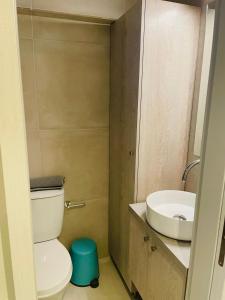 a bathroom with a toilet and a sink at Sophia's studio in Saronida