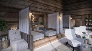 a living room with two beds and two chairs at Schiefergut Family Resort Flachau in Flachau +50 photos