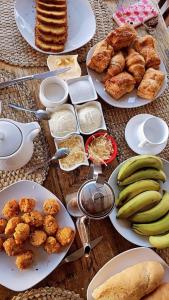 a table with plates of food and bananas and pastries at Royal Attitude in Port Mathurin
