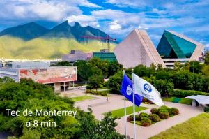 a city with two flags in front of a building at Depa Loft Monterrey cerca de Fundidora, Macroplaza y Barrio Antiguo in Monterrey +31 photos