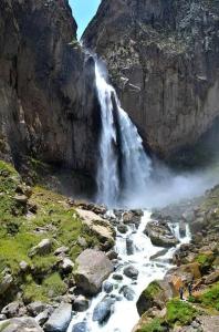 a waterfall on the side of a mountain at Fure Wassi Hostel in Cabanaconde