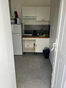 a small kitchen with white cabinets and a counter at studios N5 in Le Mans