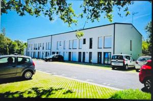 a white building with cars parked in front of it at Studio confortable central in La Roche-sur-Yon