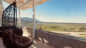 a balcony with a swing and a view of a field at Sublime Bnb in Shkodër