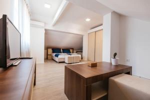 a living room with a bed and a couch at Apartment Stari Pazar in Konjic