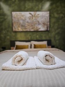 a pair of towels sitting on top of a bed at Dimitra's house in Aridaia