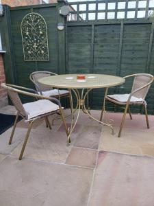 a table and two chairs and a table and chairs at Trent Cottage in Newark-on-Trent