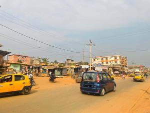 a group of cars driving down a city street at Rieti Yamehome in Yaoundé
