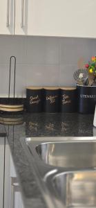 a kitchen counter with a sink and some dishes at Minnestayairbnb in Gaborone