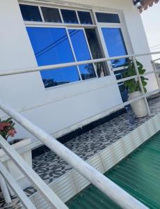 a balcony of a house with a window at Amour Coco Stay in Chaki Chaki