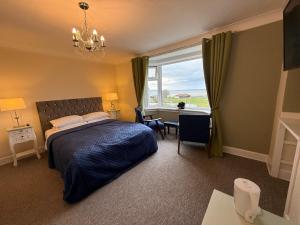 a bedroom with a bed and a desk and a window at "SUPERB-SEA-VIEWS"ROOM ONLY at WETHERBY NAIRN in Nairn