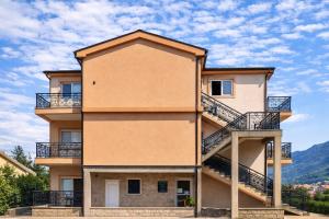 a building with balconies and stairs on it at Apartments Zenit in Kotor +2 photos