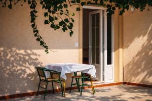 a table and chairs in front of a door at Apartments Zenit in Kotor