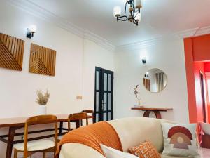 a living room with a couch and a table at Rieti Yamehome in Yaoundé