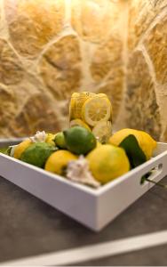a white tray filled with lemons and other fruit at Casa Bella a Skala 1 in Skala +14 photos