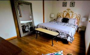 a bedroom with a bed and a large mirror at Casa Hortencia in Coñaripe