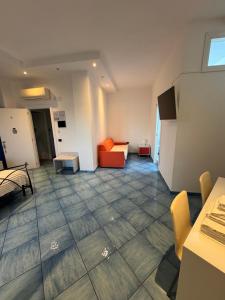 a living room with a couch and a chair at Blue Sea Salerno in Salerno