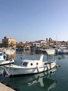 a boat is docked in a harbor with other boats at Oikiaegina in Egina