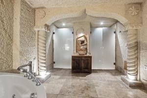 a large bathroom with a tub and a sink at Tatlı Kaya Cave Otel in Ürgüp +85 photos