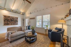 a living room with a couch and a table at Walkable Designer Cottage In GV in Columbus