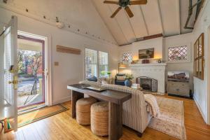 a living room with a couch and a table at Walkable Designer Cottage In GV in Columbus