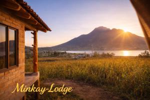 a house with a view of a mountain and a lake at Minkay-Lodge in Otavalo