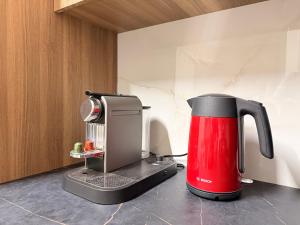 a red and black coffee maker sitting on a counter at Nicosia Neoclassic Retreat in Nicosia