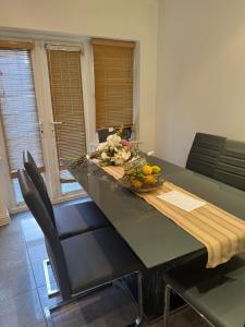 a dining room table with a bowl of fruit on it at Cosy House in Reading