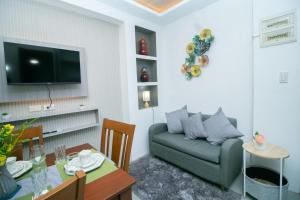 a living room with a couch and a table at 206 Executive Granvia Suites in Cagayan de Oro