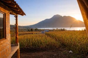 a house with a view of a lake and a mountain at Minkay-Lodge in Otavalo