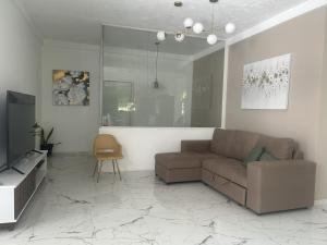 a living room with a couch and a chair at Quinta Pompella in San Salvador