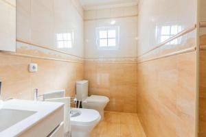 a bathroom with a toilet and a sink at The Refuge Mosteiros house in Mosteiros