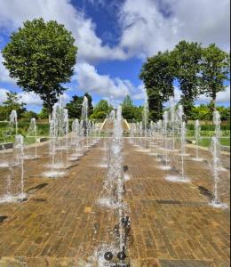 a row of water fountains in a park at studios N5 in Le Mans