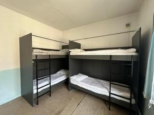 a room with three bunk beds in a room at Sunny Hostel in Osh
