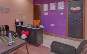 a room with a purple and purple door and a table at Super Hotel O Surya Inn in Varanasi