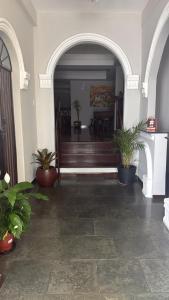 a hallway with potted plants in a building at Pousada Tropeira in Lapa