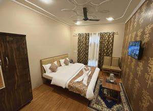 a bedroom with a bed and a table and a couch at Faizzy residency in Srinagar