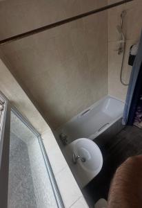 a bathroom with a bath tub and a sink at Quiet room 3 in Coventry