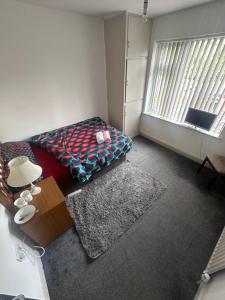 a living room with a couch and a window at Quiet room 3 in Coventry