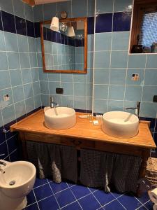 a bathroom with two sinks and a mirror at Chalet La Terrazza Vista Lago in Bellano +15 photos