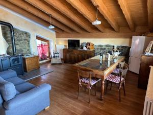 a kitchen with a wooden table and a blue couch at Chalet La Terrazza Vista Lago in Bellano