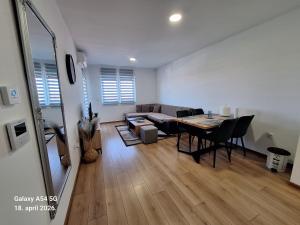 a living room with a table and a couch at Stan na dan UNO Modriča in Modriča +10 photos